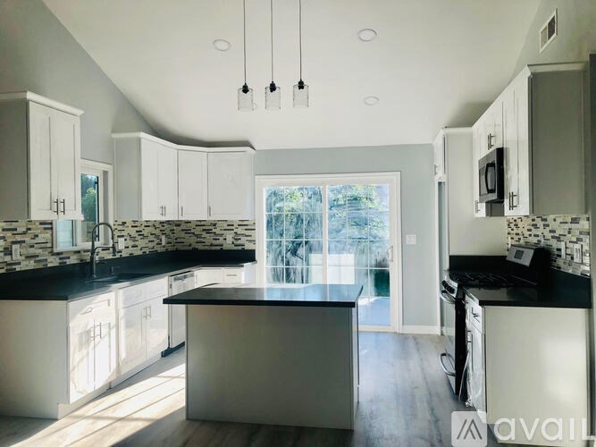 A kitchen with a large island in the middle.