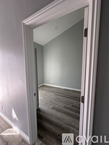 A room with a wooden floor and white walls.
