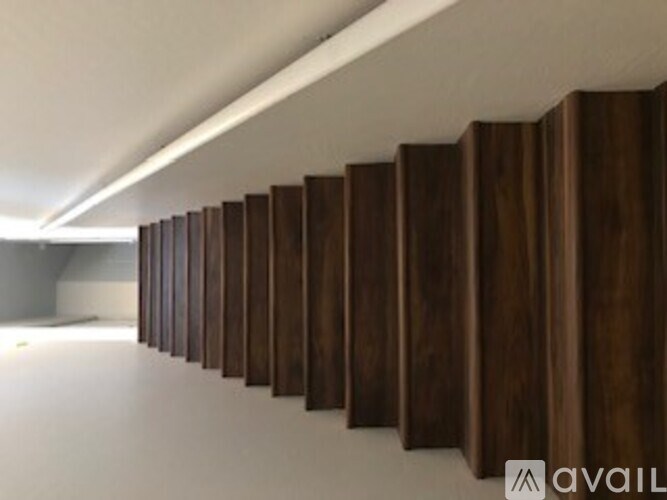 A wall of wood paneling is installed in a room.