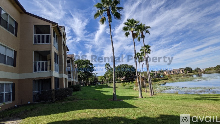 A building with palm trees in front of it.