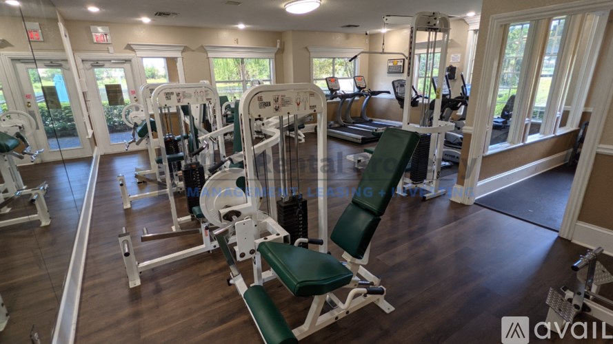 A gym with a variety of equipment including treadmills, weights, and exercise machines.