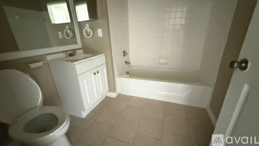 A bathroom with a toilet, sink, and bathtub.