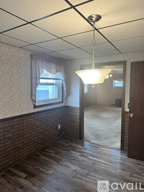 A room with a brick wall and wooden flooring.