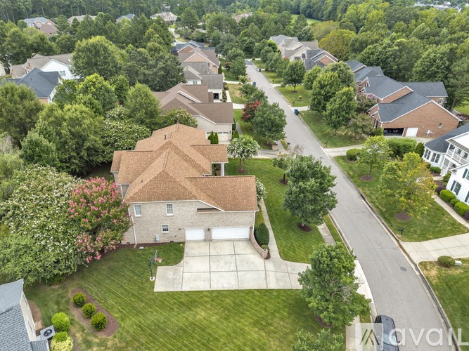A bird's eye view of a suburban neighborhood with houses and trees.