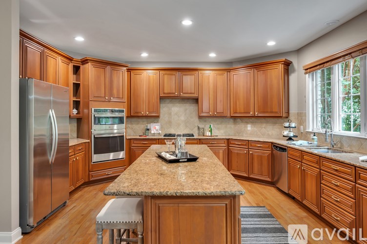 A kitchen with wooden cabinets and a granite countertop.