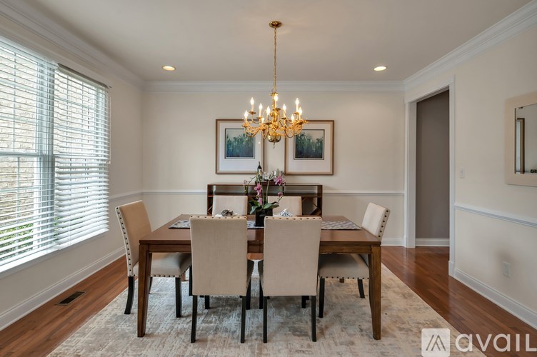 A dining room with a table set for six.