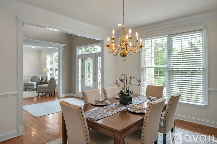 A dining room with a wooden table and chairs.
