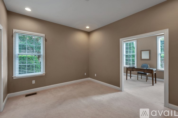 A room with brown walls and a carpeted floor.