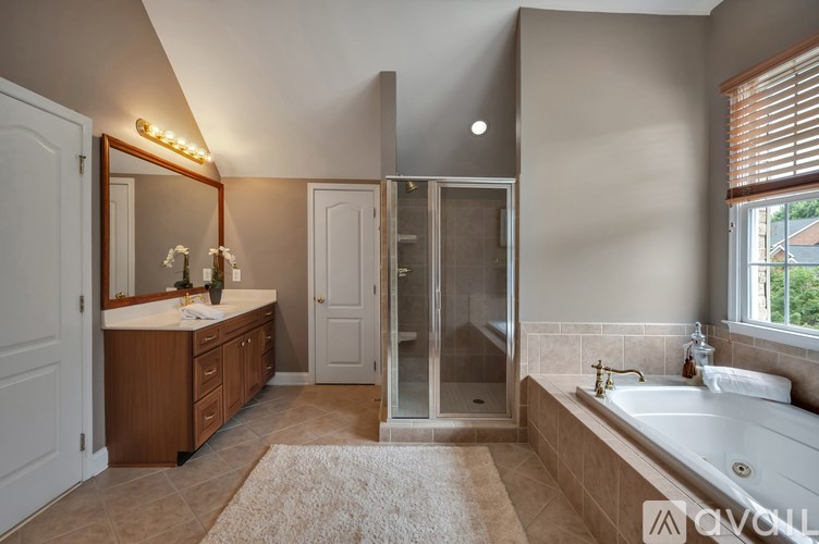 A bathroom with a large mirror and a walk-in shower.