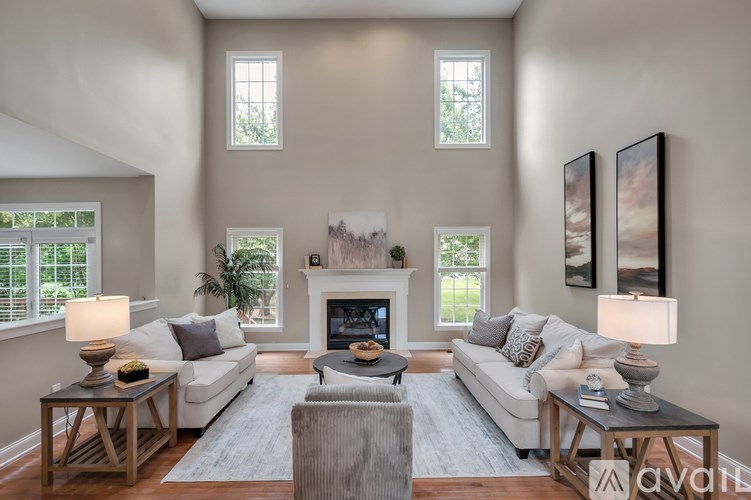 A living room with a fireplace and two couches.
