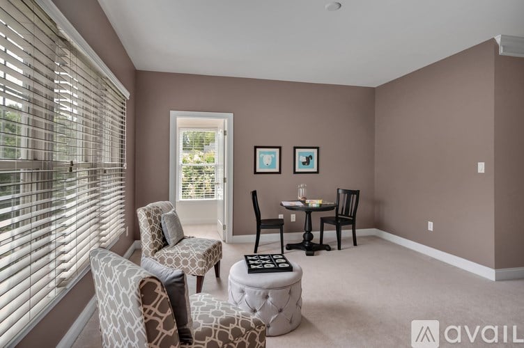 A living room with a dining table and chairs.