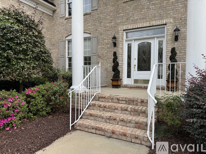 A house with a white door and steps leading up to it.