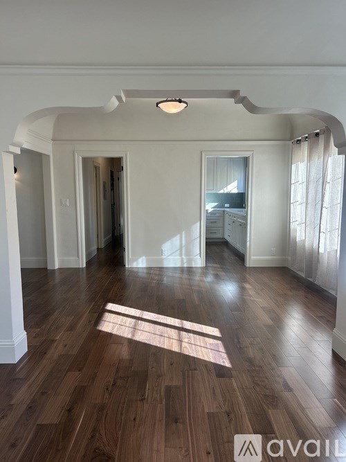 A room with wooden floors and white walls.