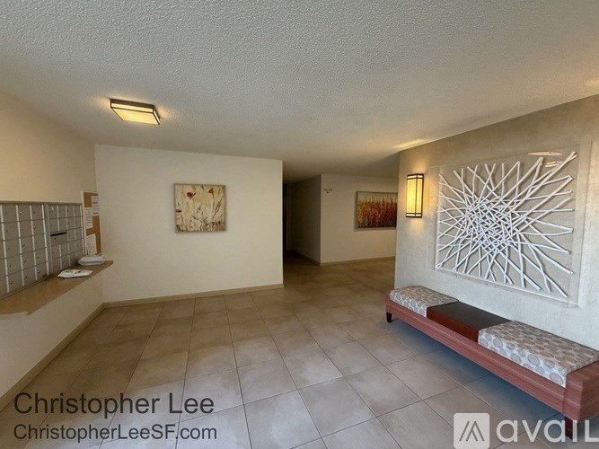 A room with a bench and a wall art.