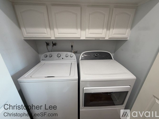 A white washing machine and dryer in a small laundry room.
