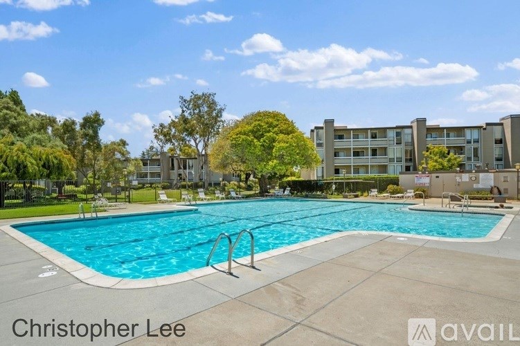 A swimming pool in front of apartment buildings.