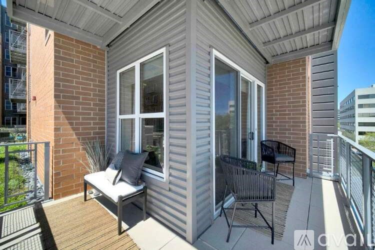A balcony with a bench and a chair.