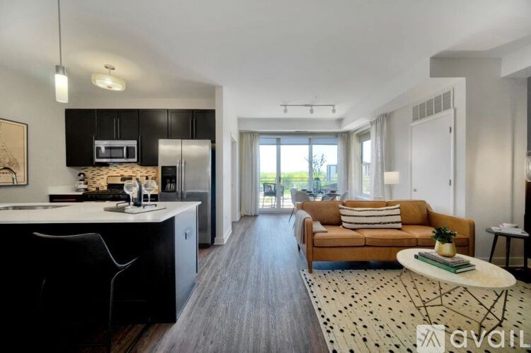 A modern kitchen with black cabinets and a wooden island.