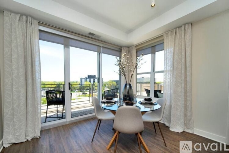 A dining room with a table set for two and a view of the city.