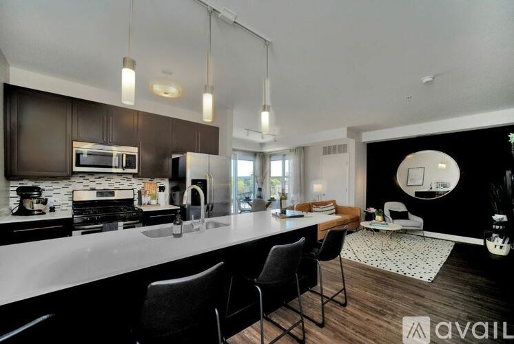 A modern kitchen with dark brown cabinets and a white countertop.