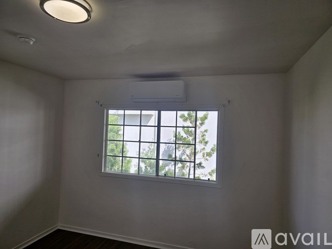 A room with a window and a ceiling light.