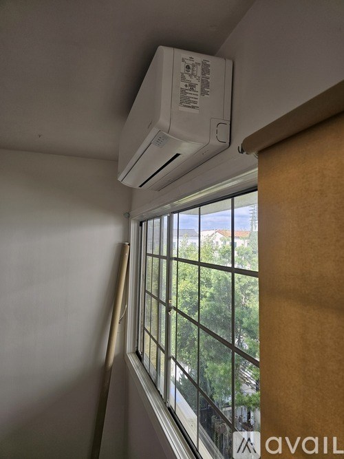 A wall-mounted air conditioner is installed above a window.