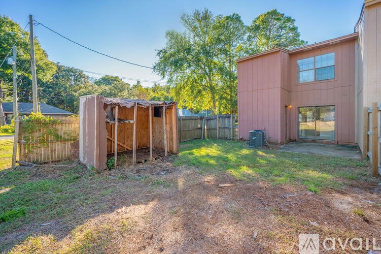A backyard with a shed and a house.