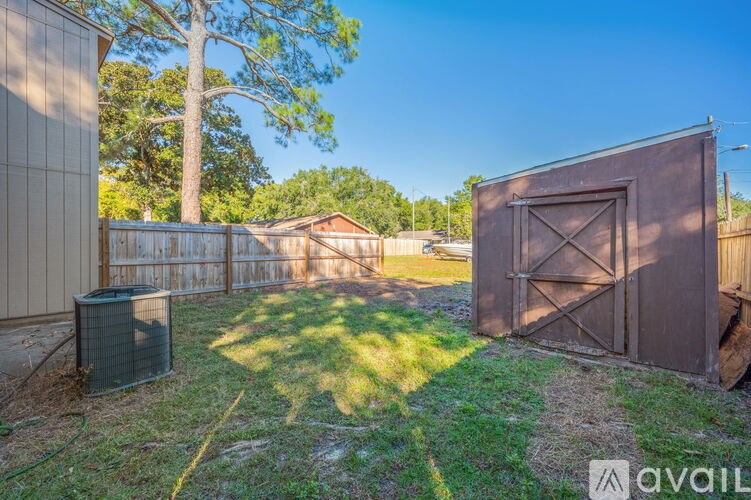 A brown gate is closed with a metal latch.