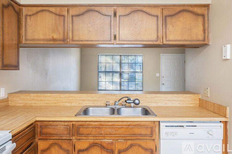 A kitchen with wooden cabinets and a washing machine.