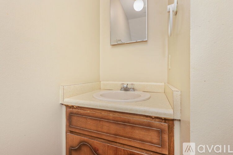 A bathroom with a sink and a mirror above it.