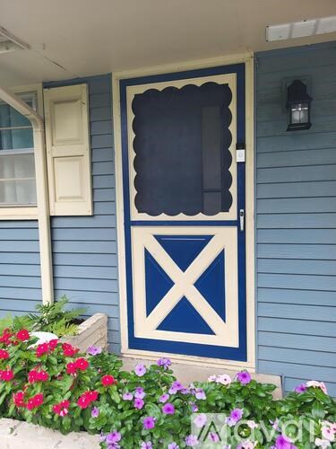 A blue and white door with a window above it.