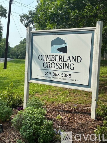 A sign for Cumberland Crossing with a phone number on it.