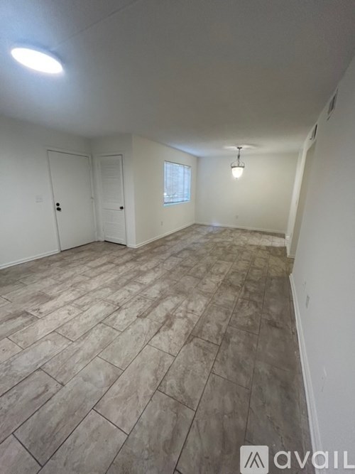 A room with a tiled floor and a window.