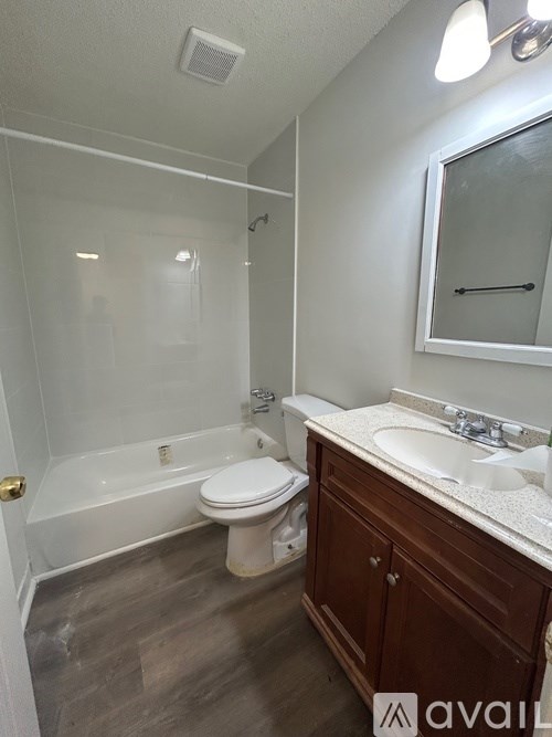 A bathroom with a toilet, sink, and bathtub.