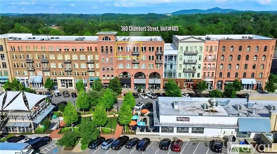 A parking lot with cars and a building in the background.