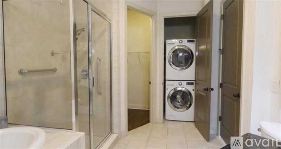 A bathroom with a washer and dryer in it.