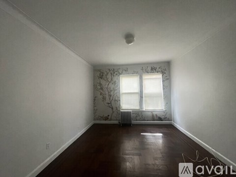 A room with a window and a radiator on the wall.