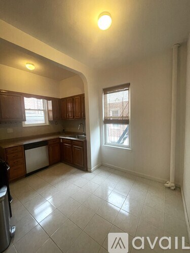A kitchen with a dishwasher and a window.