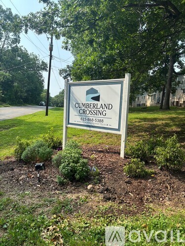A sign for Cumberland Crossing stands in a grassy area.