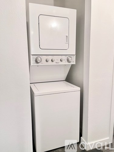 A white oven with a door and knobs on the front.