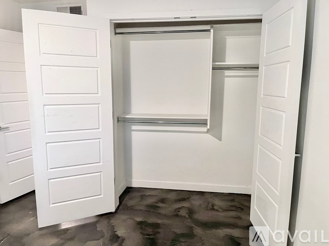 A white closet with a sliding door and shelves.