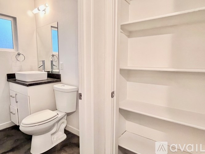 A white toilet and sink in a small bathroom.