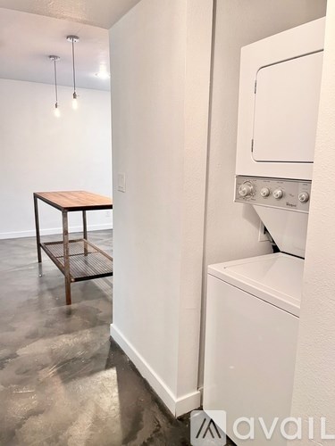 A white oven is installed in a kitchen with a wooden table.
