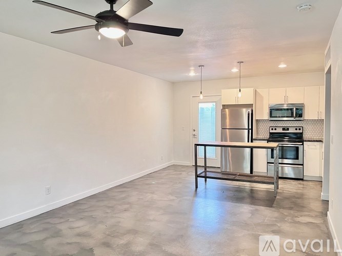 A kitchen with a stainless steel refrigerator, microwave, and oven is shown.
