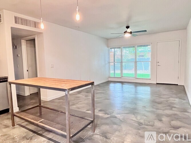A room with a table and a fan.