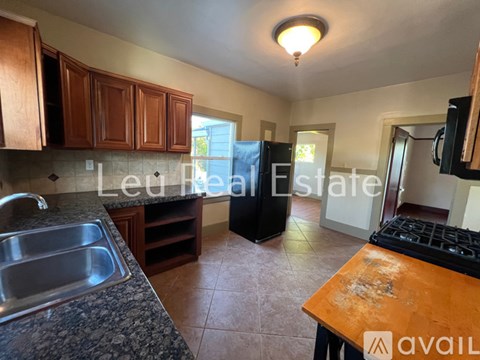 A kitchen with a sink and a stove top.