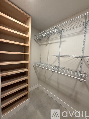 A walk-in closet with shelving and drawers.