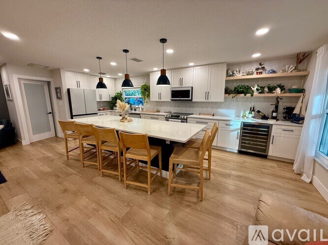A kitchen with a table and chairs in the middle of the room.