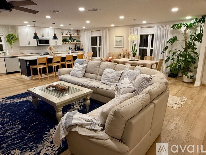 A living room with a large sectional sofa and a coffee table.