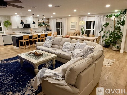 A living room with a large sectional sofa and a coffee table.